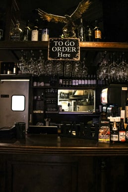 Restaurant takeout order pickup area with a “To Go Order Here” sign.