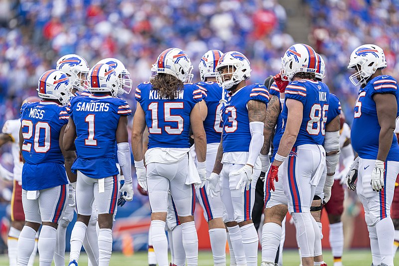 A group of Buffalo Bills huddle before an offensive play